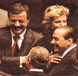 Le belle facce della banda di papisti che tramite il Pid tiene in ostaggio quel che resta della Sinistra italiana: Renzo Lusetti mentre sghignazza (ma con occhi umilmente bassi) con Silvio Berlusconi.