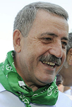 Guido Podestà ritratto mentre ci rende impossibile chiamarlo "portatore di moccichino verde".